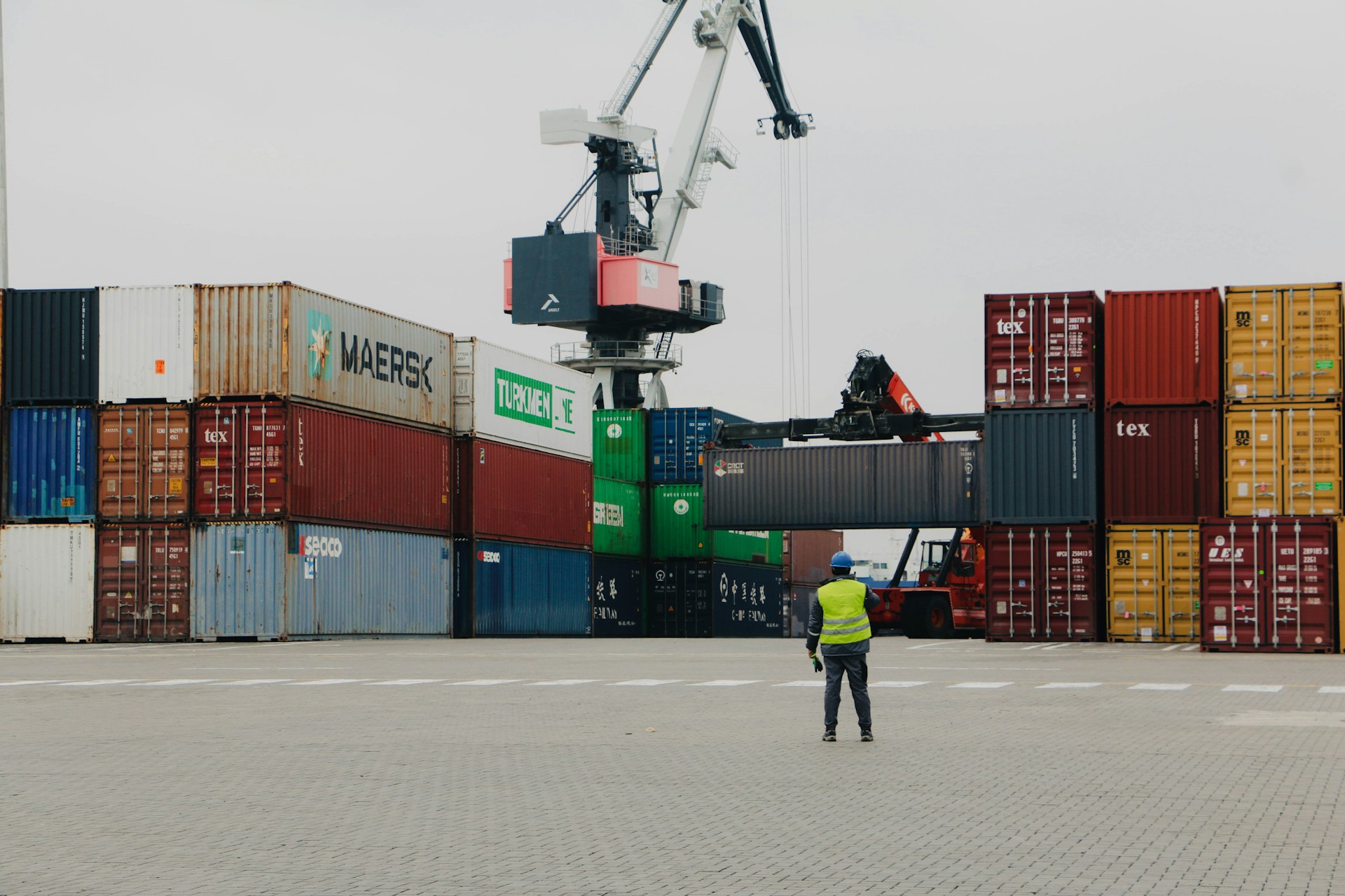 A man standing in front of a large crane